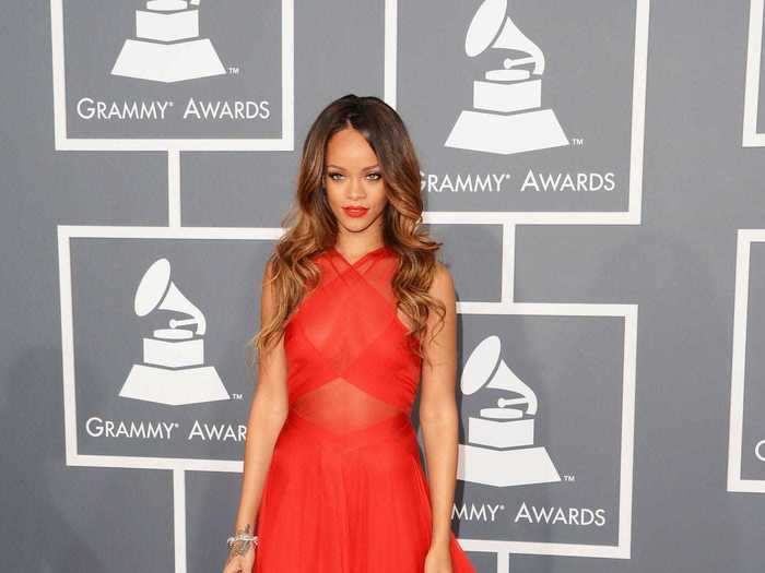 February 2013: Rihanna hit the red carpet in an unforgettable custom red gown designed by Alaia, and went home with a Grammy.