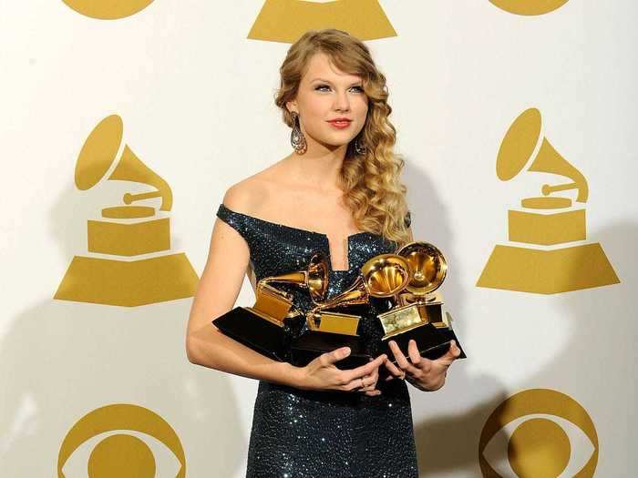 February 2010: Taylor Swift gathered her four Grammys in a deep blue off-the shoulder, mermaid-style gown.