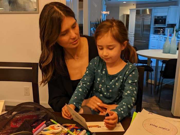 Rincon takes a break in the afternoon to review flashcards with her daughter, who