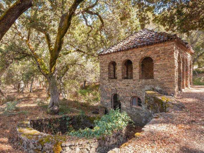 In one quiet corner of the grounds sits a rustic two-story teahouse that has a kitchen and a covered patio area.