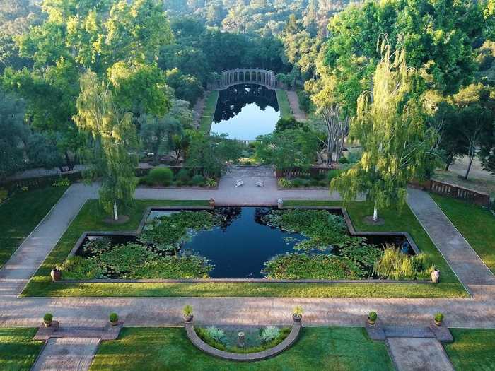 The main home overlooks a 60-by-300-foot Roman pool with an aqueduct-like stone edifice.