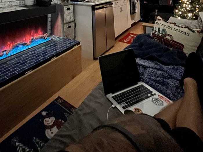 Across from the fireplace and the collapsible coffee table is a couch that can double as a bed.