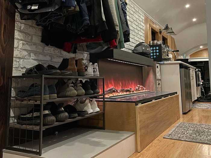 The kitchen flows into the living room, which has a 56-inch fireplace. Gordnier can change the color of the stones and the lighting in the fireplace.