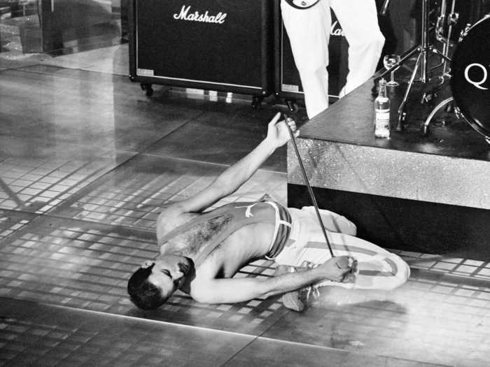 1984: Freddie Mercury shows off his flexibility on stage while performing at the Golden Rose Pop festival in Montreux, Switzerland.