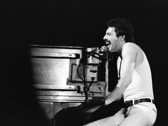 1980: Freddie Mercury sings at the piano during a show at the National Exhibition Centre in Birmingham, England.