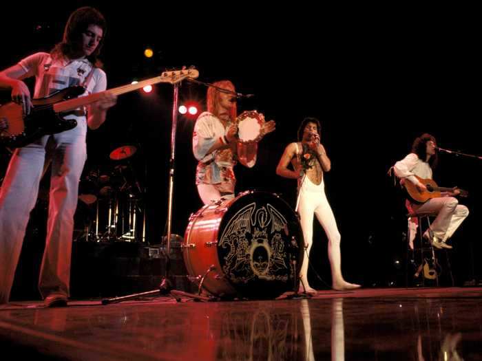 1977: All four members of Queen perform side-by-side at Madison Square Garden in New York City.