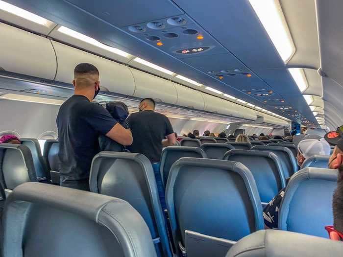 Just after the boarding door closed, a stampede of passengers flocked forward and nearly every row in my section filled up.