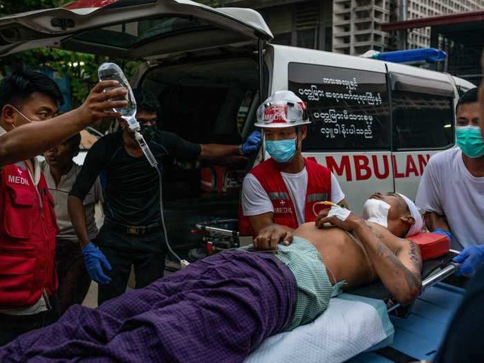 Medics transport an injured protester to hospital on a stretcher.