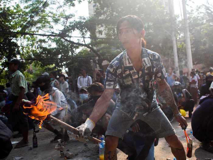 Outside, protesters hunkered down behind barricades with crude weapons in hand.