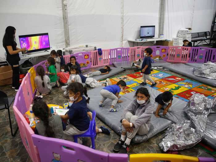 The youngest children are kept in a large play pen and monitored by a caretaker.
