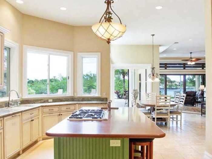 The kitchen has a large island and a pantry for storage.