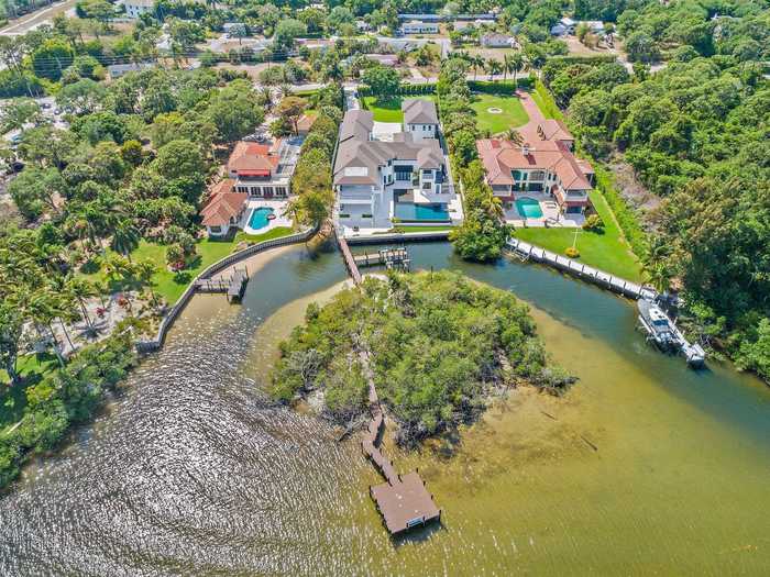 The waterfront mansion has a private island and a private boat ramp.