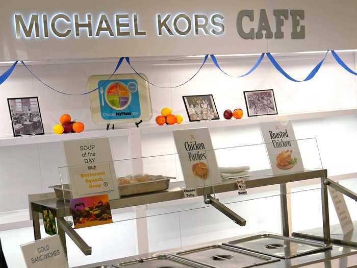 The cafeteria is in the space that once held Michael Kors products, and signs of the building