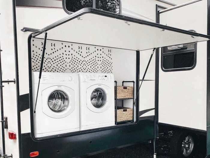 Out back, the RV has a laundry room with a washer and dryer.