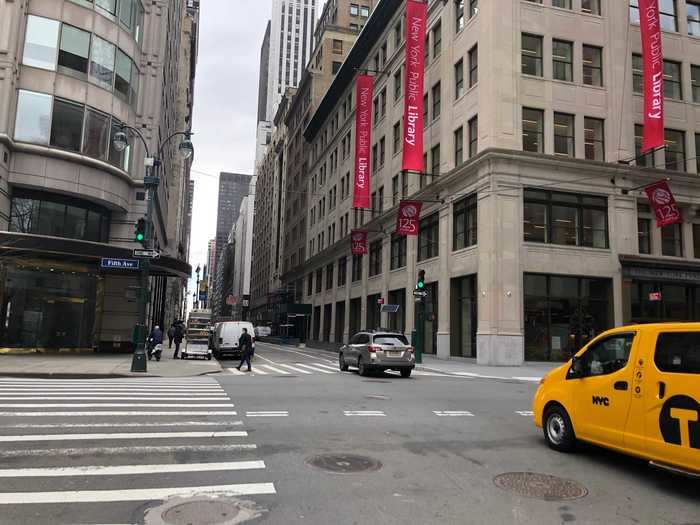 That same intersection today has traffic and pedestrians again.