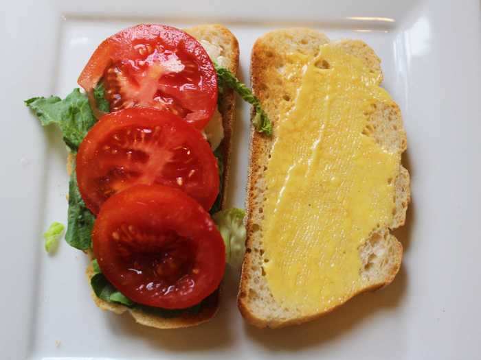 Next, I topped the buttered side of my sandwich with lettuce and tomato.