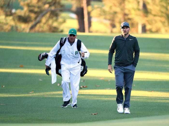 Players are allowed to use their own caddies now, but they have to wear the Augusta uniform - green hat, white jumpsuit.