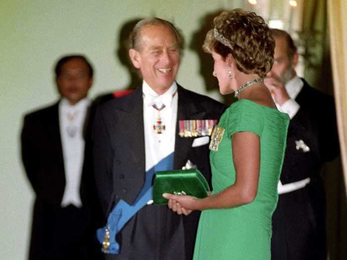 1993: The Duke of Edinburgh chats with Diana, Princess of Wales, at a banquet he is hosting in honour of the Queen.