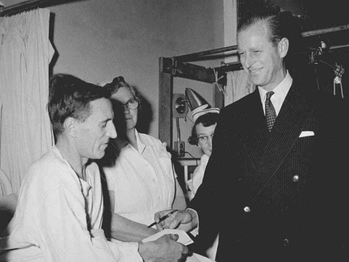 1958: Here, Prince Philip is handing a pen back to Levi Milley after signing an autograph.