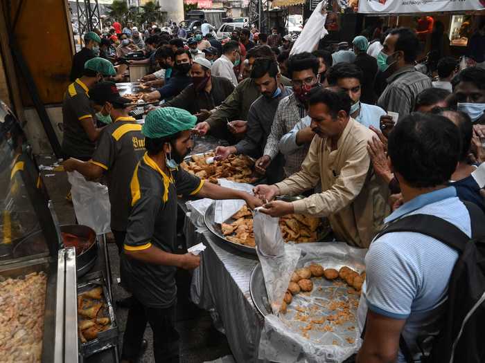 Though COVID restrictions remain in many places this year, festive crowds still gathered in mosques and shopping centers to pray and buy food.