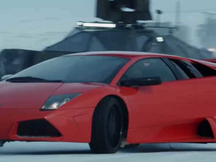 Roman struggles to drive across ice in a bright orange Lamborghini in "F8."