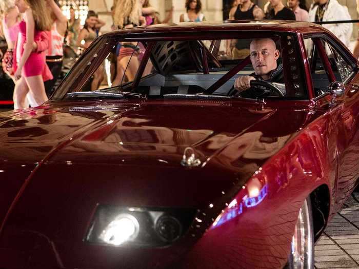 Dom drives a gorgeous red Dodge Charger Daytona during a street race with Letty.