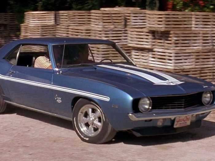 Brian drives a 1969 Yenko Camaro SYC off a pier onto a boat.