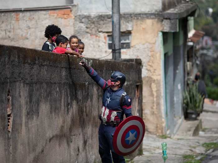 Yet some are still trying to bring some joy amid the heartbreak. Military police officer Everaldo Pinto donned a Captain America costume to hand out face masks and teach children how to avoid contracting COVID-19 in a city north of Rio de Janeiro this week.