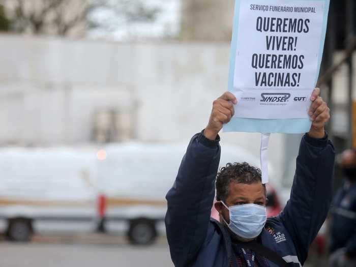 Funeral service workers protested in Sao Paulo this week, asking for more protection. "We want to live! We want vaccines!" this protester