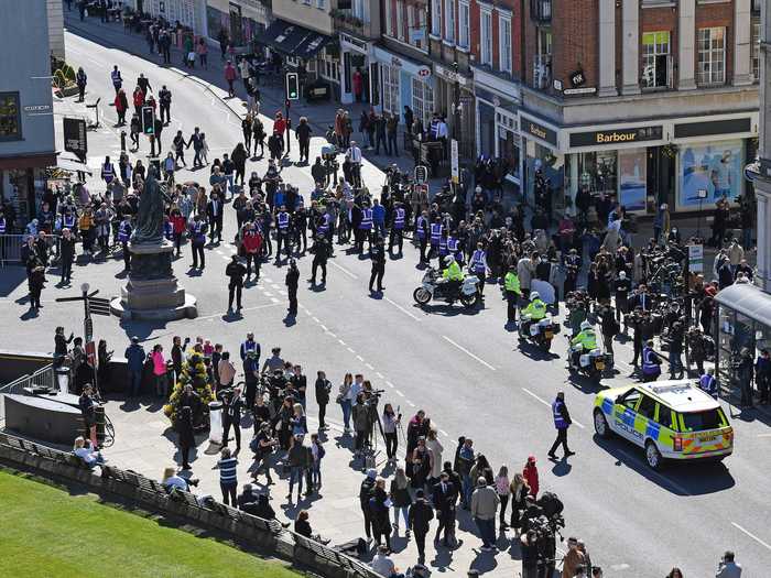 Police had to block traffic for a coach for the funeral as mourners gathered in the streets.