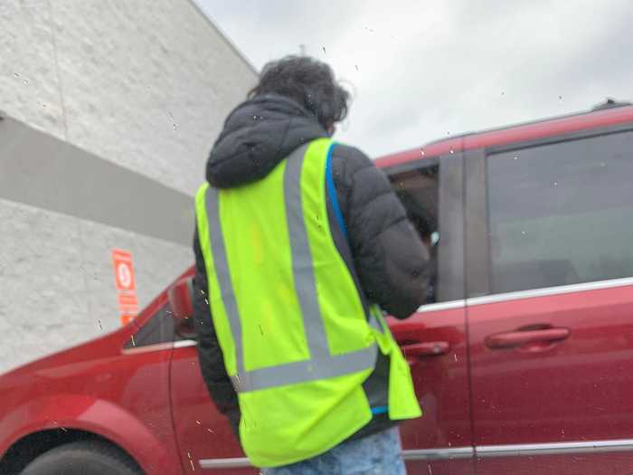 Masked shoppers come up to the driver