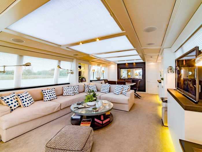 The yacht has a spacious central seating area inside.