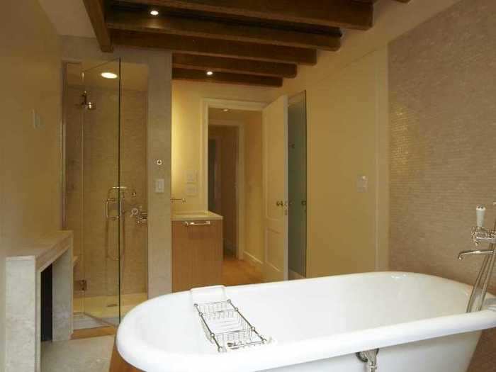 Across the hall is the master bathroom with a tub and steam shower. There