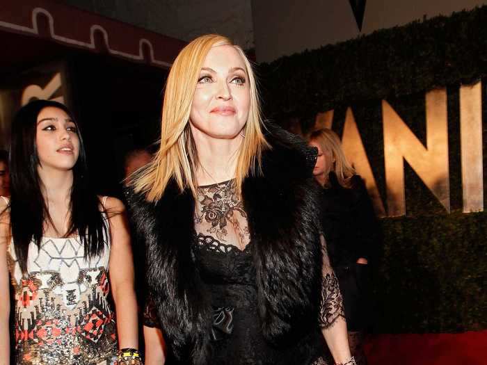 2011: Madonna chose a black bodysuit with a sheer lace overlay and a fur stole for the red carpet.