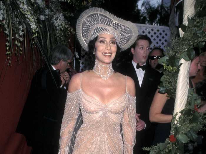 1998: Cher opted for a completely see-through dress dripping in crystals with a matching crystal hat and choker.