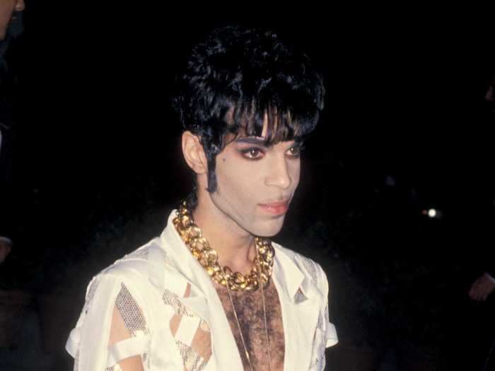 1994: Prince accessorized a sheer white jumpsuit with a lollipop and a thick gold chain.