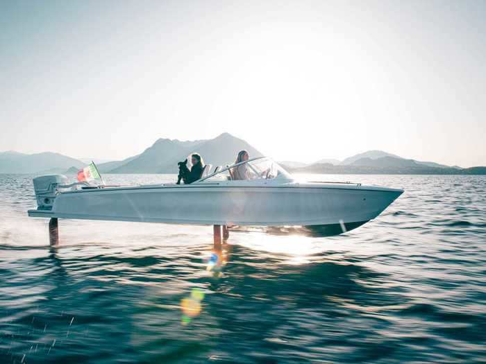 It uses hydrofoils, combined with computers and sensors, to lift it over the surface of the water so that it almost looks like it