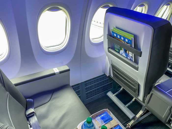 Seat-backs feature large literature holders and while there are no in-flight entertainment screens, device holders are found attached to the tray table.