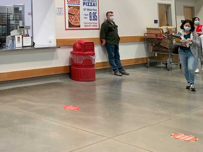 Social distancing markers on the ground serve as reminders to stay six feet away from workers and other customers.