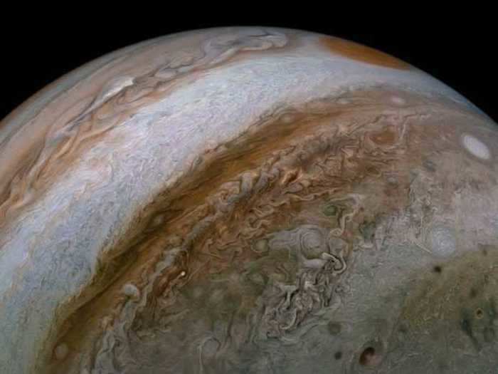 This image captures the extensive jet streams on Jupiter to show the turbulent atmosphere penetrating the gas giant planet.