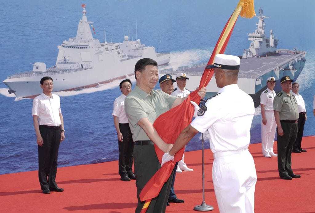 Chinese President Xi Jinping, also general secretary of the Communist Party of China Central Committee and chairman of the Central Military Commission, presents People