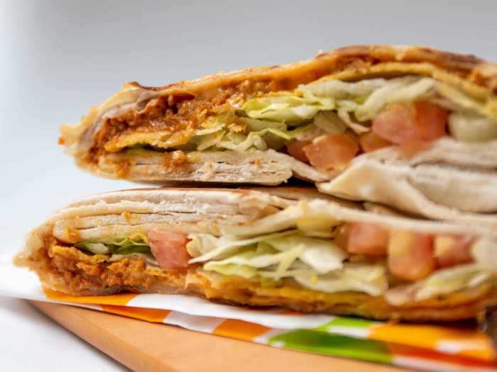 The Crunchwrap Supreme comes with tomato, lettuce, a protein, queso, a hard corn tortilla, and sour cream, all inside of a folded and pressed tortilla.