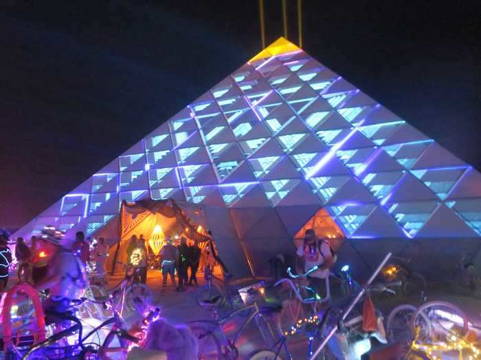 At night, Burning Man lights up with people and bicycles covered in electroluminescent wire and art structures featuring LED lights.