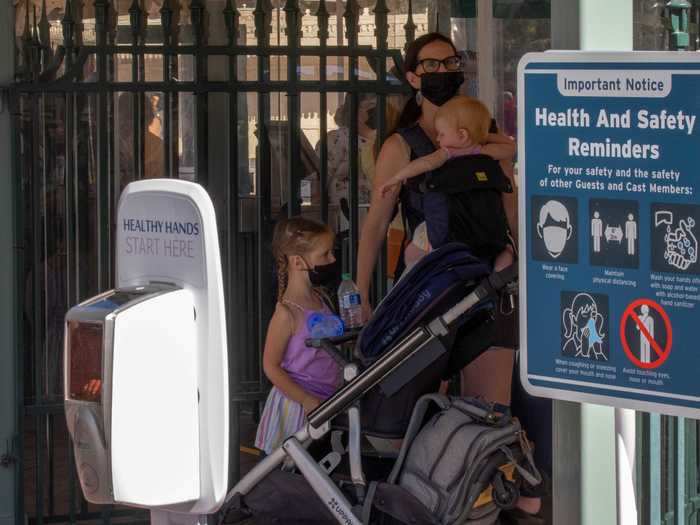 Sanitizing stations are all around the park along with signs reminding guests to follow pandemic procedures like wearing a mask and staying away from other groups.