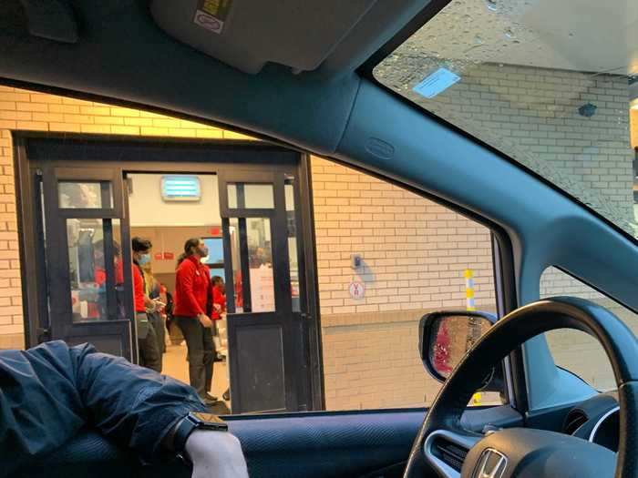 The area where windows would be in any other fast-food drive-thru is instead a large sliding door, which workers are constantly running in and out of, transporting food.