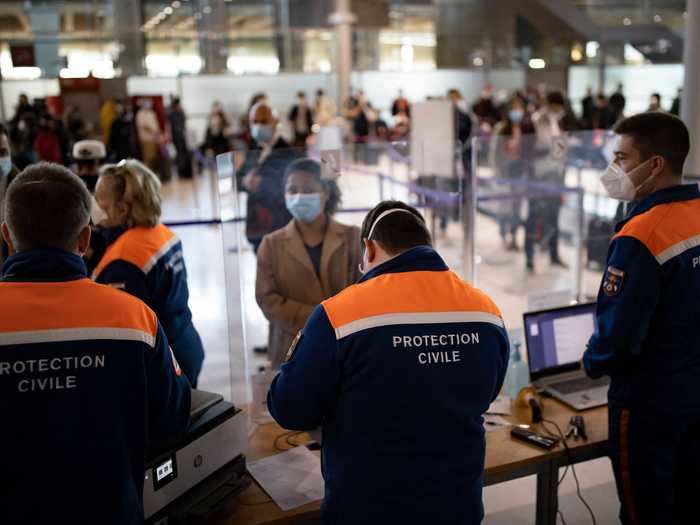 At an airport in France, crowds of visitors from countries in the COVID-19 red zone register for coronavirus tests upon arrival.