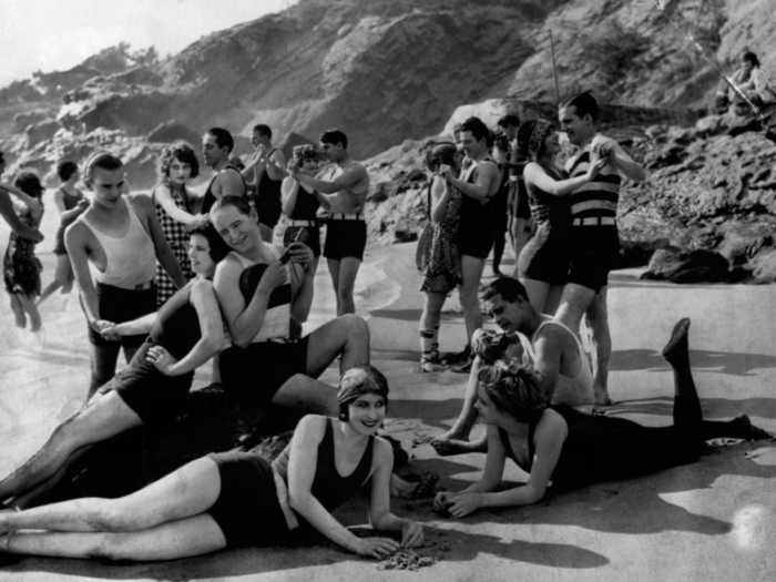 While women primped for garden gatherings, they sported more daring styles at the beach. Popular bathing outfits at the time had more revealing necklines than pre-war swimsuits.