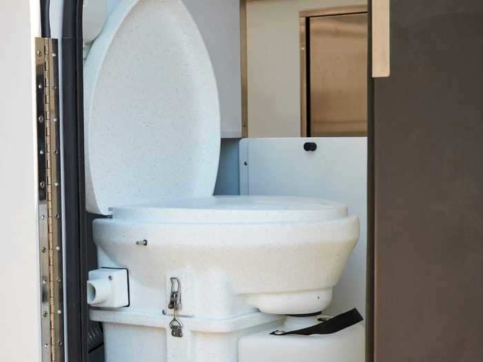 Beyond the front door is the mud room and a pull-out composting toilet that hides away when it