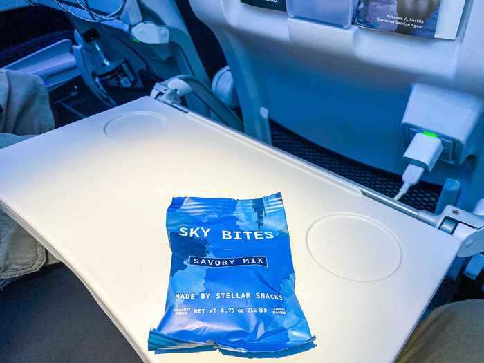 Flight attendants began the in-flight service shortly after takeoff, starting with a bag of snack mix.