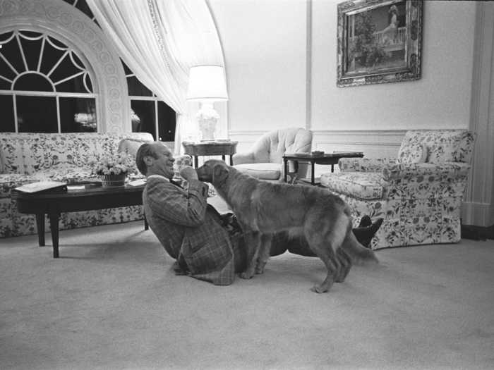 President Gerald Ford was photographed with his golden retriever, Liberty, in the second story family room of the White House executive residence in 1975.